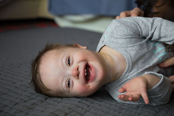 Portrait of cute baby boy with Down syndrome