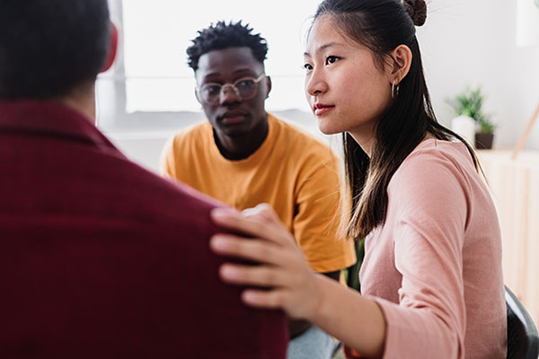 Meeting of young people in group therapy supporting each other at community center.